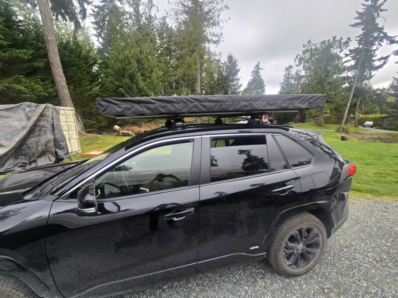 Trail Lite roof tent mounted on a vehicle, offering compact and durable camping solution for overland adventures.