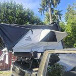 Outland XL™ ABS hard shell rooftop tent mounted on an SUV, featuring a spacious elevated sleeping platform with a durable weatherproof shell, telescopic ladder, and four-season camping design for families and overlanding adventures.