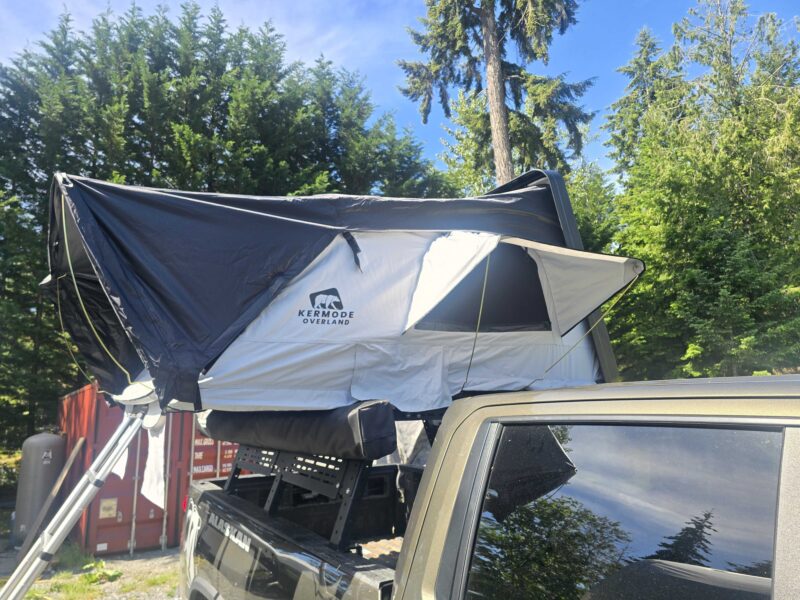 Outland XL™ ABS hard shell rooftop tent mounted on an SUV, featuring a spacious elevated sleeping platform with a durable weatherproof shell, telescopic ladder, and four-season camping design for families and overlanding adventures.