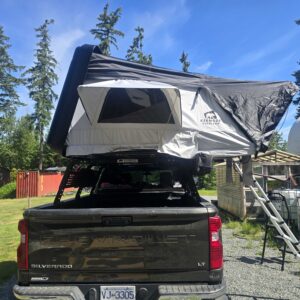 Outland XL™ ABS hard shell rooftop tent mounted on an SUV, featuring a spacious elevated sleeping platform with a durable weatherproof shell, telescopic ladder, and four-season camping design for families and overlanding adventures.